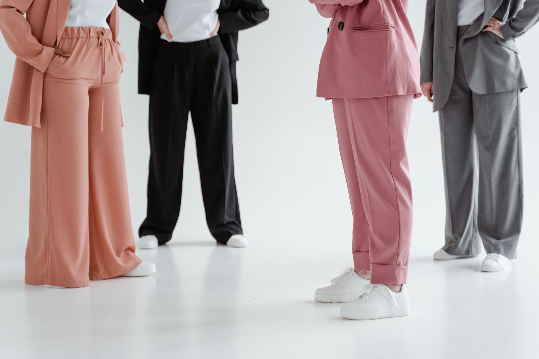 side-by-side comparison of a structured sheath dress and a blazer-trouser combination at equivalent price points