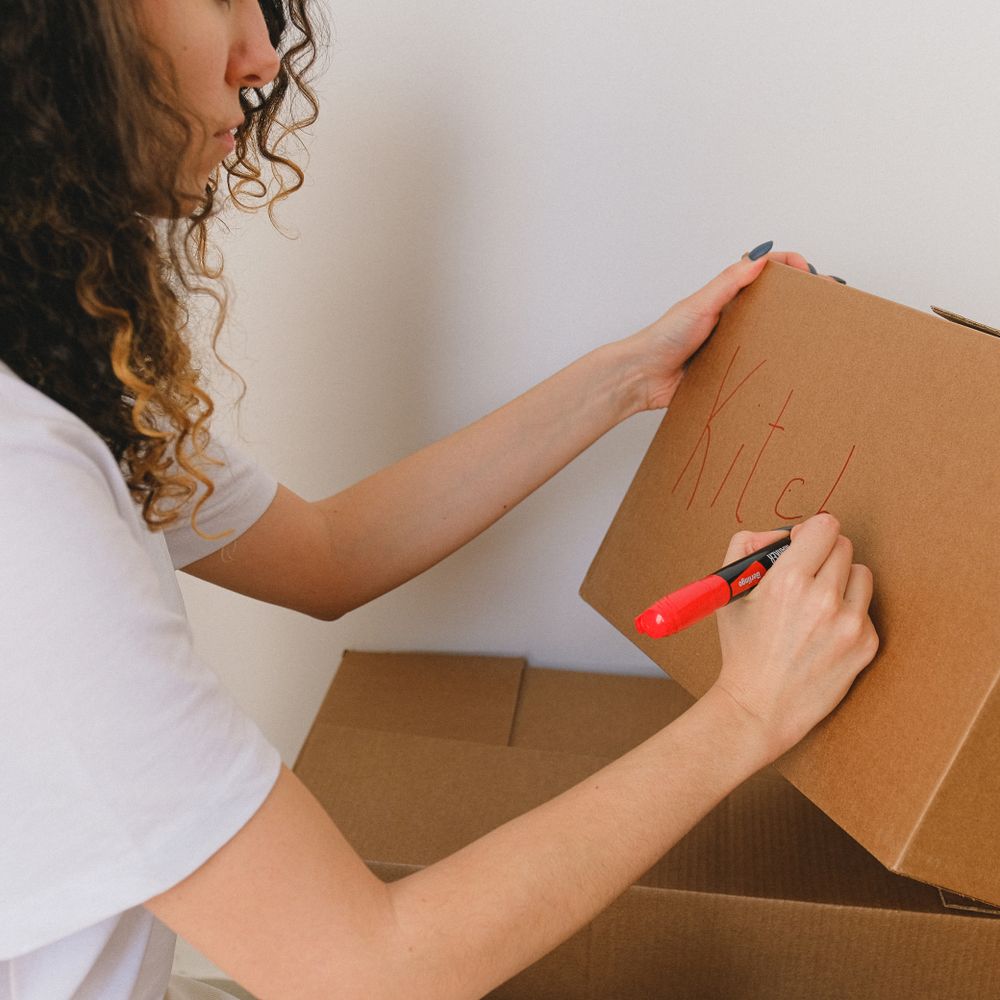 Hackbridge — movers carrying boxes for a flat move