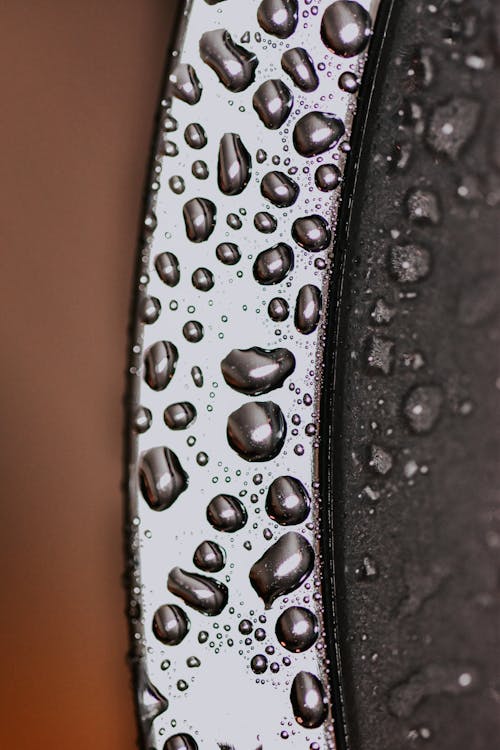 Water drops on metal surface in daylight