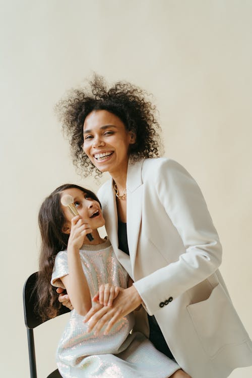 Free Woman in White Blazer with Her Daughter Smiling Stock Photo