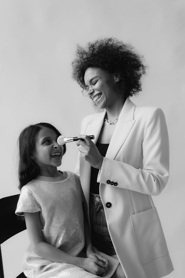 Mom Putting On Makeup On Daughter