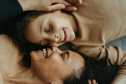 Free Woman and Child Lying Together Stock Photo
