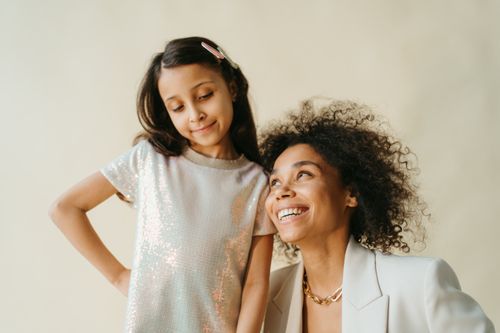 Free Joyous moment between a mother and daughter, both smiling warmly. Stock Photo