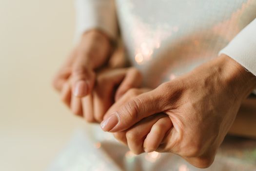Close-up of two hands gently holding, symbolizing love and connection