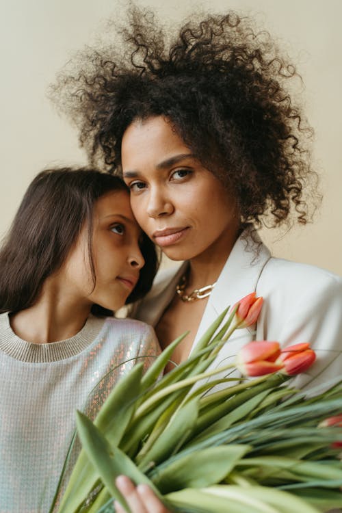 Mother and Daughter Holding Flowers