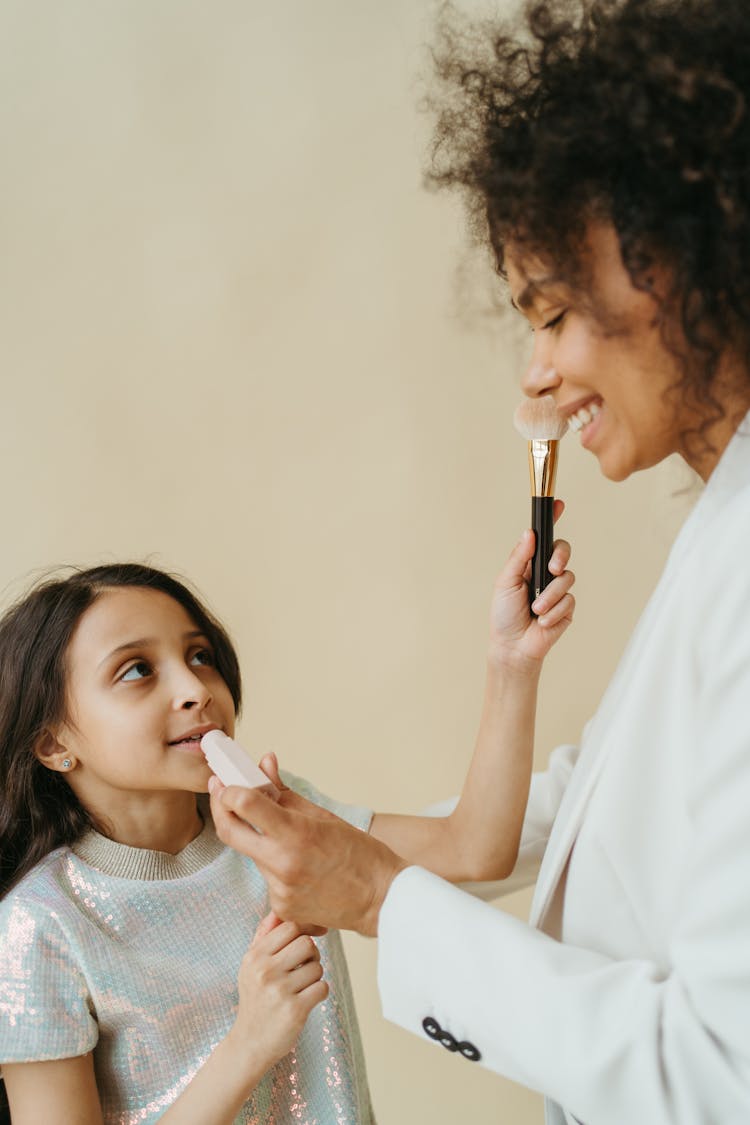 Mom And Daughter Putting On Makeup