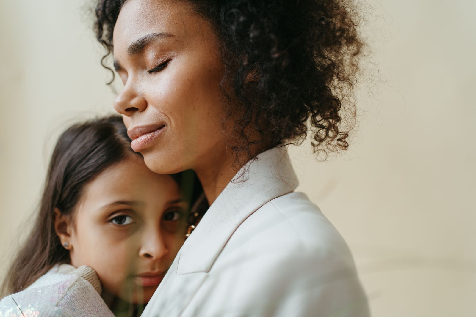 A mother and daughter holding each other close — photo by Anastasia Shuraeva on Pexels
