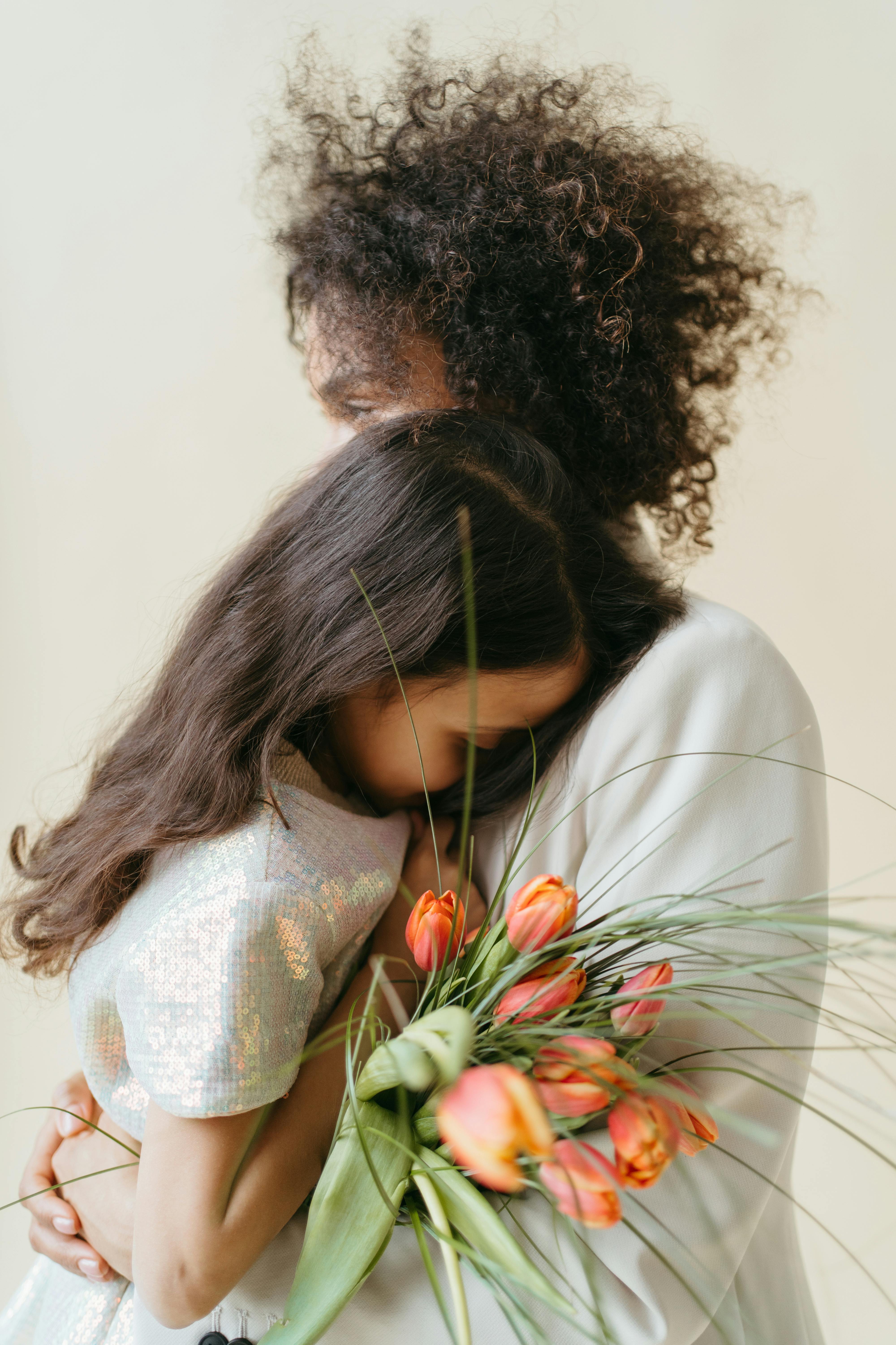 a mother and her daughter hugging