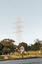 A Road Signage Near a Transmission Tower
