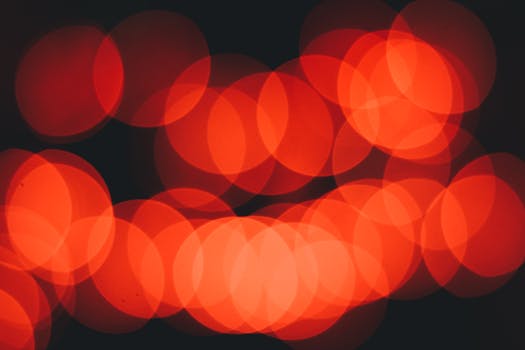 Vibrant red bokeh circles create a stunning abstract pattern on a black background.