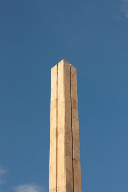 Free A tall modern concrete monument photographed against a clear blue sky, showcasing architectural design. Stock Photo
