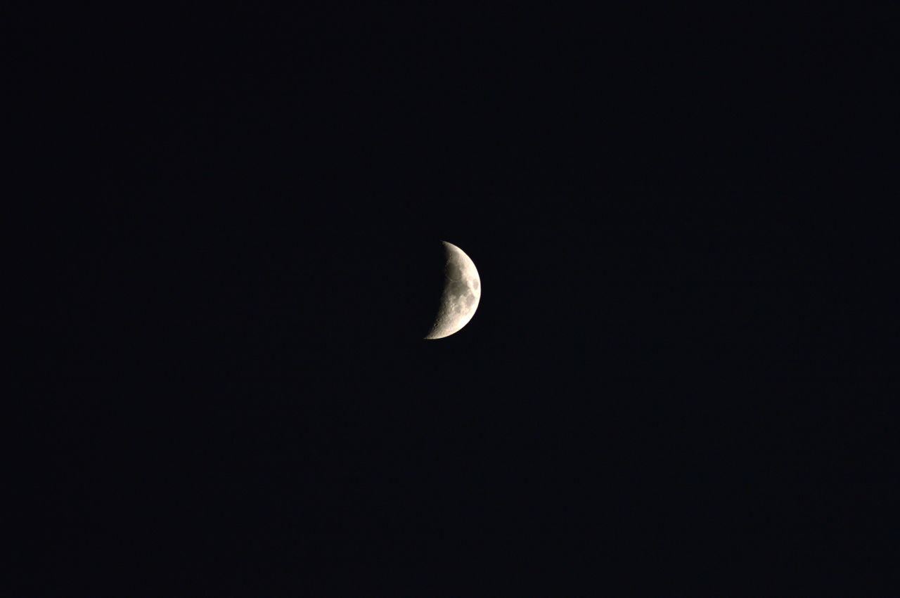 a serene crescent moon against a black night sky showcasing its timele