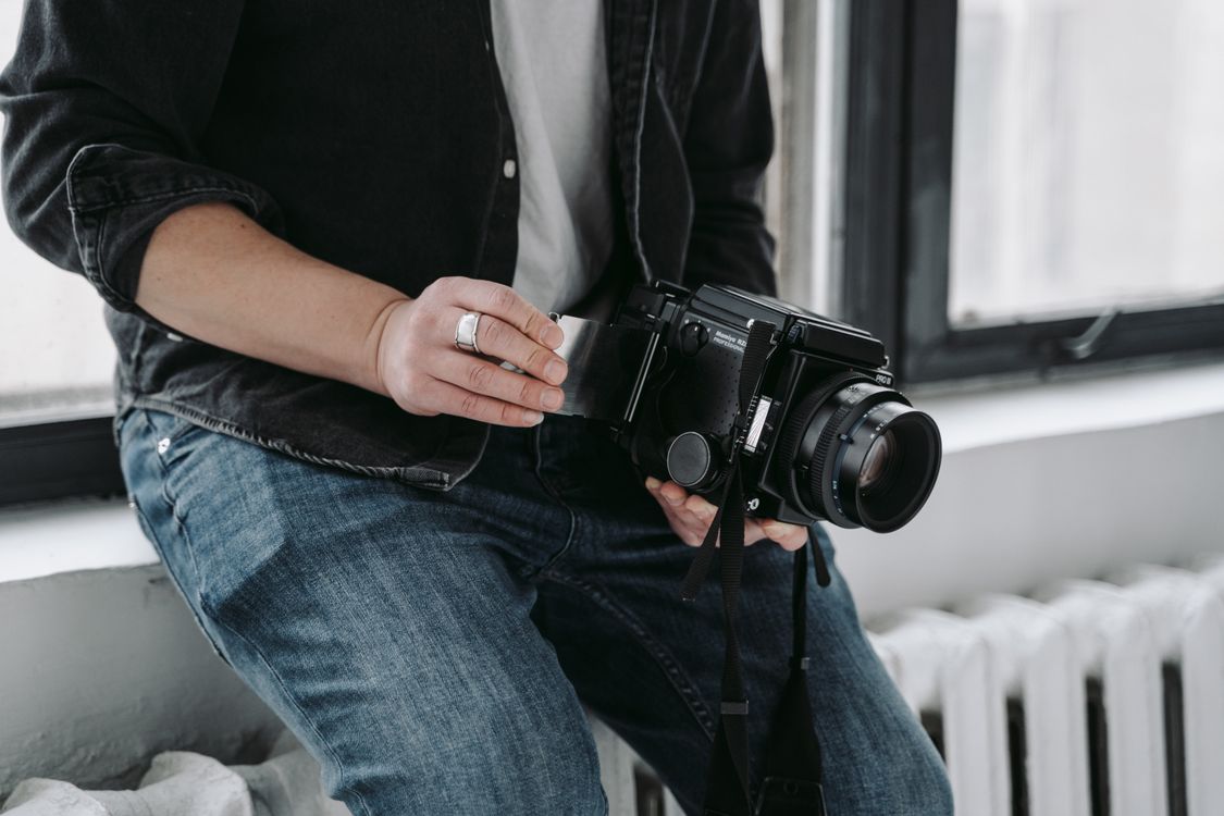 A Person Holding Black Camera · Free Stock Photo