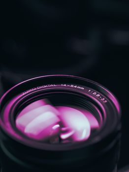 Detailed shot of a camera lens reflecting vibrant colors, perfect for photography themes.