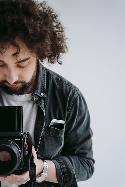 Man in Black Jacket Holding Black Camera