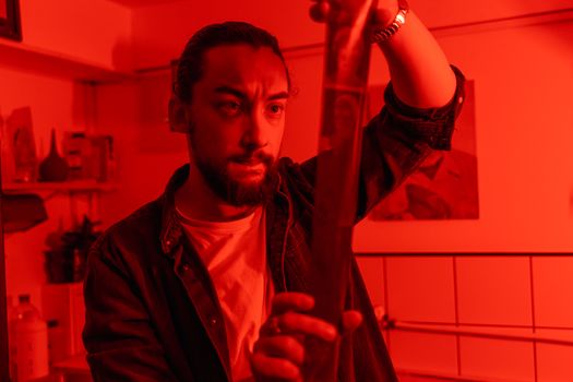 Man in Black Button Up Shirt Holding a Red Pipe