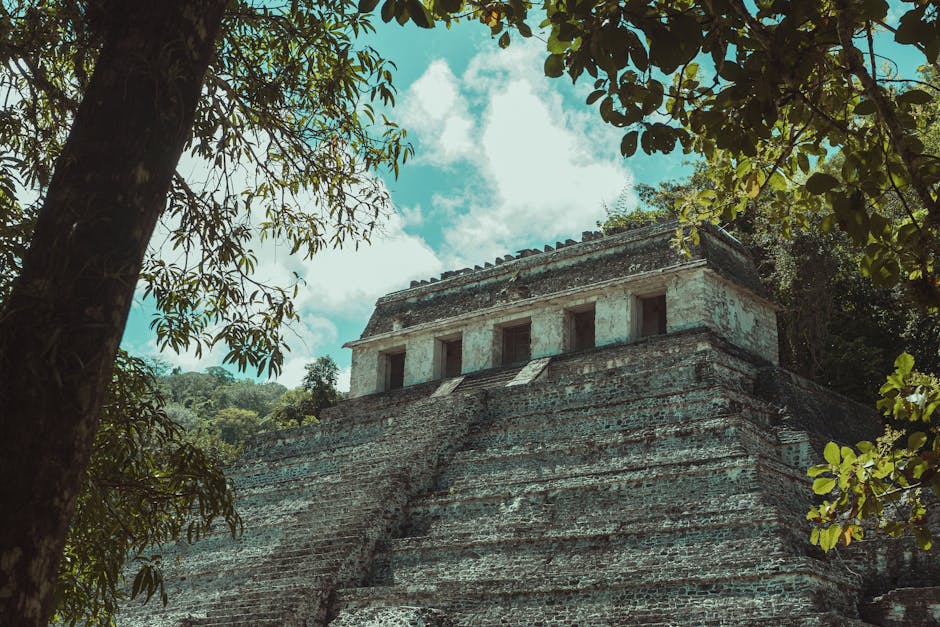 Explore the majestic ancient Mayan ruins surrounded by a dense Mexican jungle, showcasing historical architecture and natural beauty.