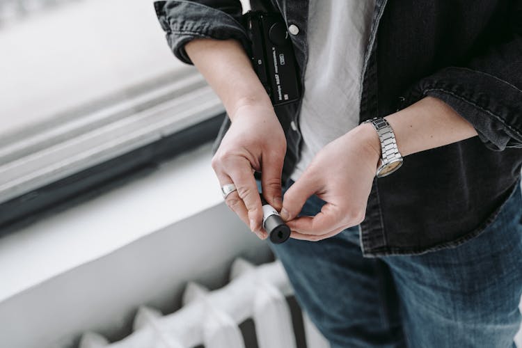 A Man Holding A Film Cartridge