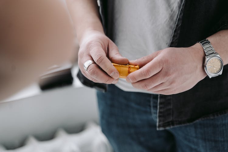 A Person Holding A Cartridge Of Film 