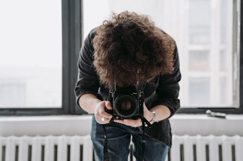 A Photographer Using a Professional Camera