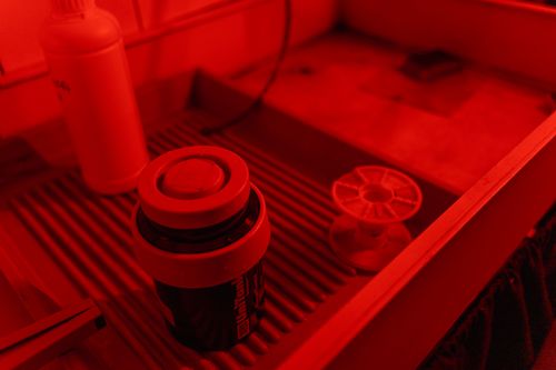 Free A darkroom setup with film developing equipment and distinct red lighting, emphasizing nostalgia. Stock Photo
