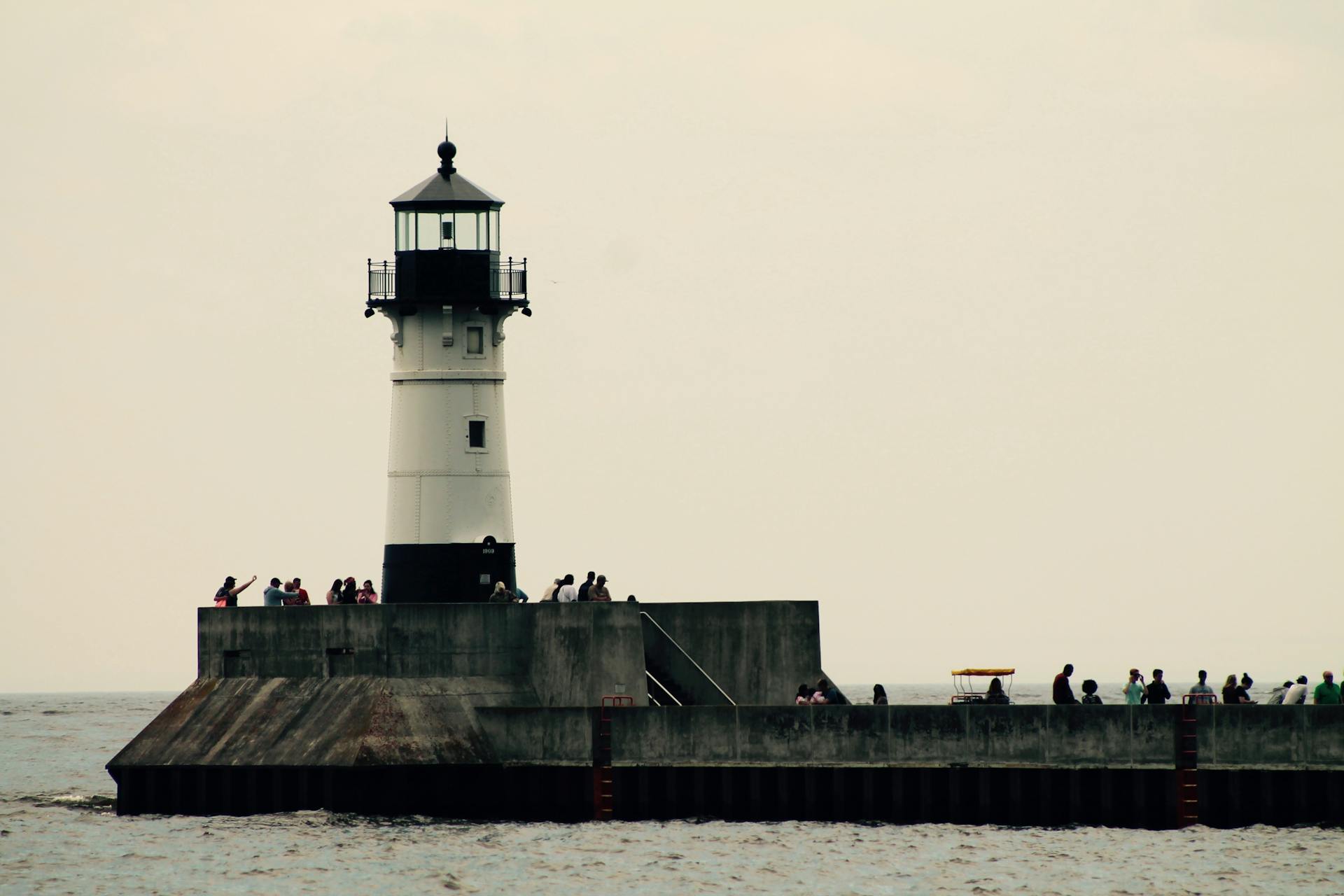 Duluth Harbor Lighthouse with visitors on the pier, USA