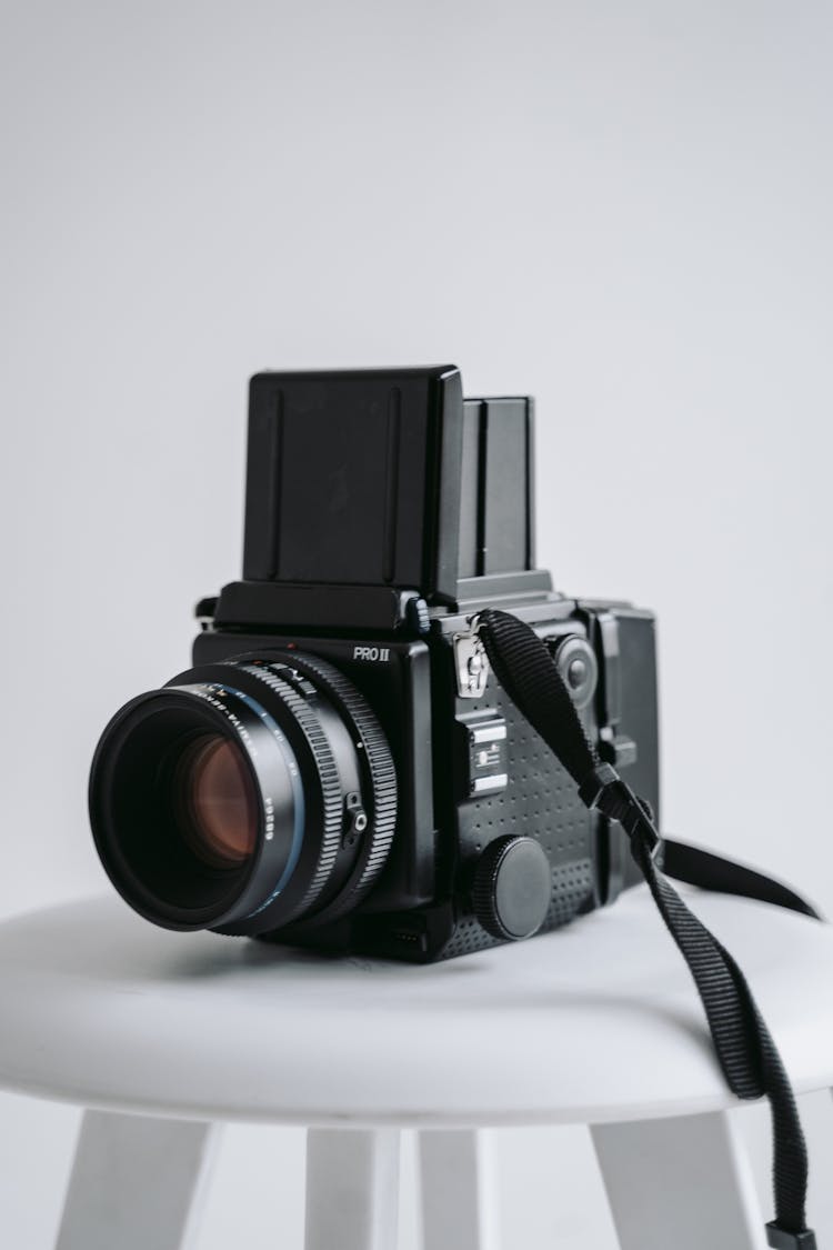 A Vintage Medium Format Camera On A White Stool