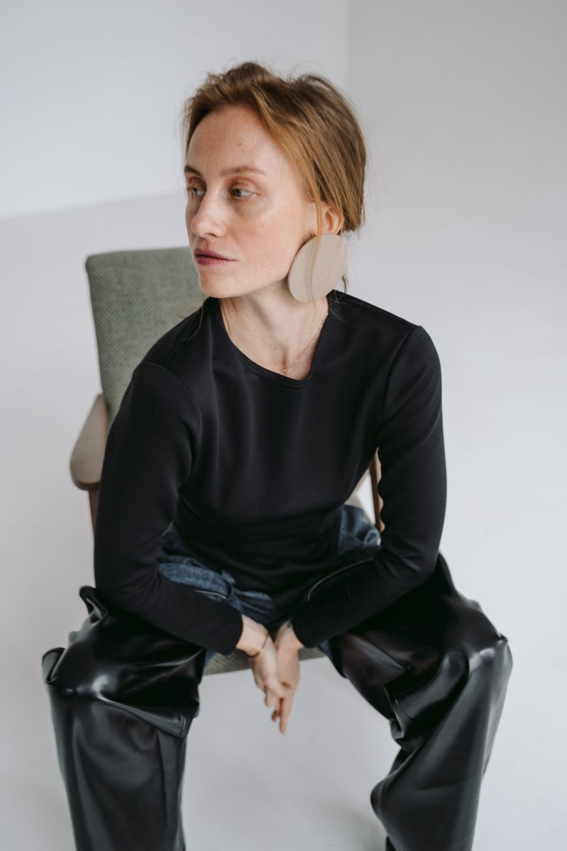 Woman in black leather pants during studio photoshoot