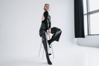Woman in Black Blazer and Black Dress Pants Sitting on Chair