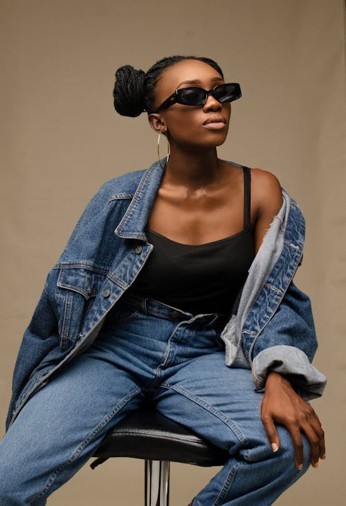 Stylish black woman in trendy outfit and sunglasses