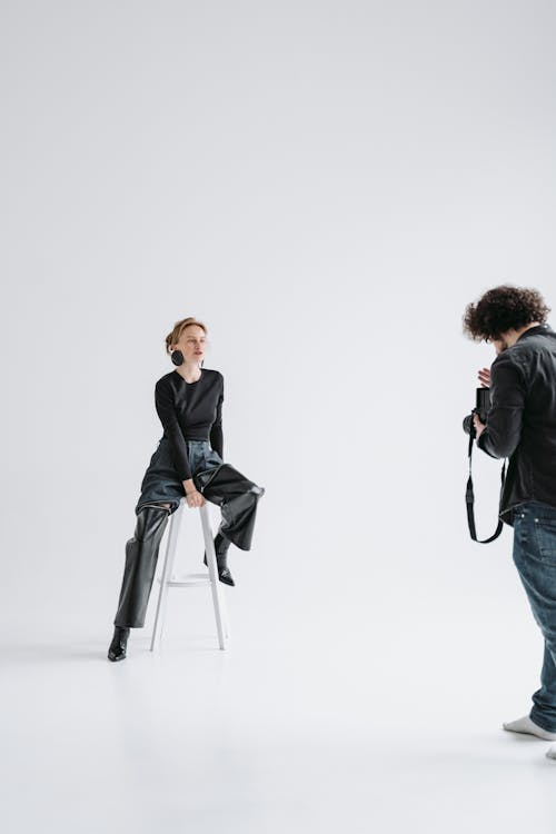A Woman and Her Photographer Having a Photoshoot in the Studio