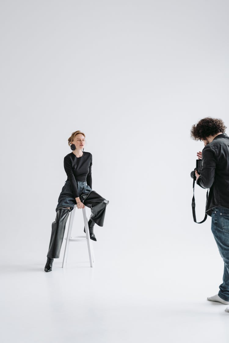 A Woman And Her Photographer Having A Photoshoot In The Studio