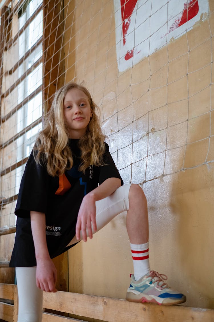 A Girl Stepping On A Wooden Plank