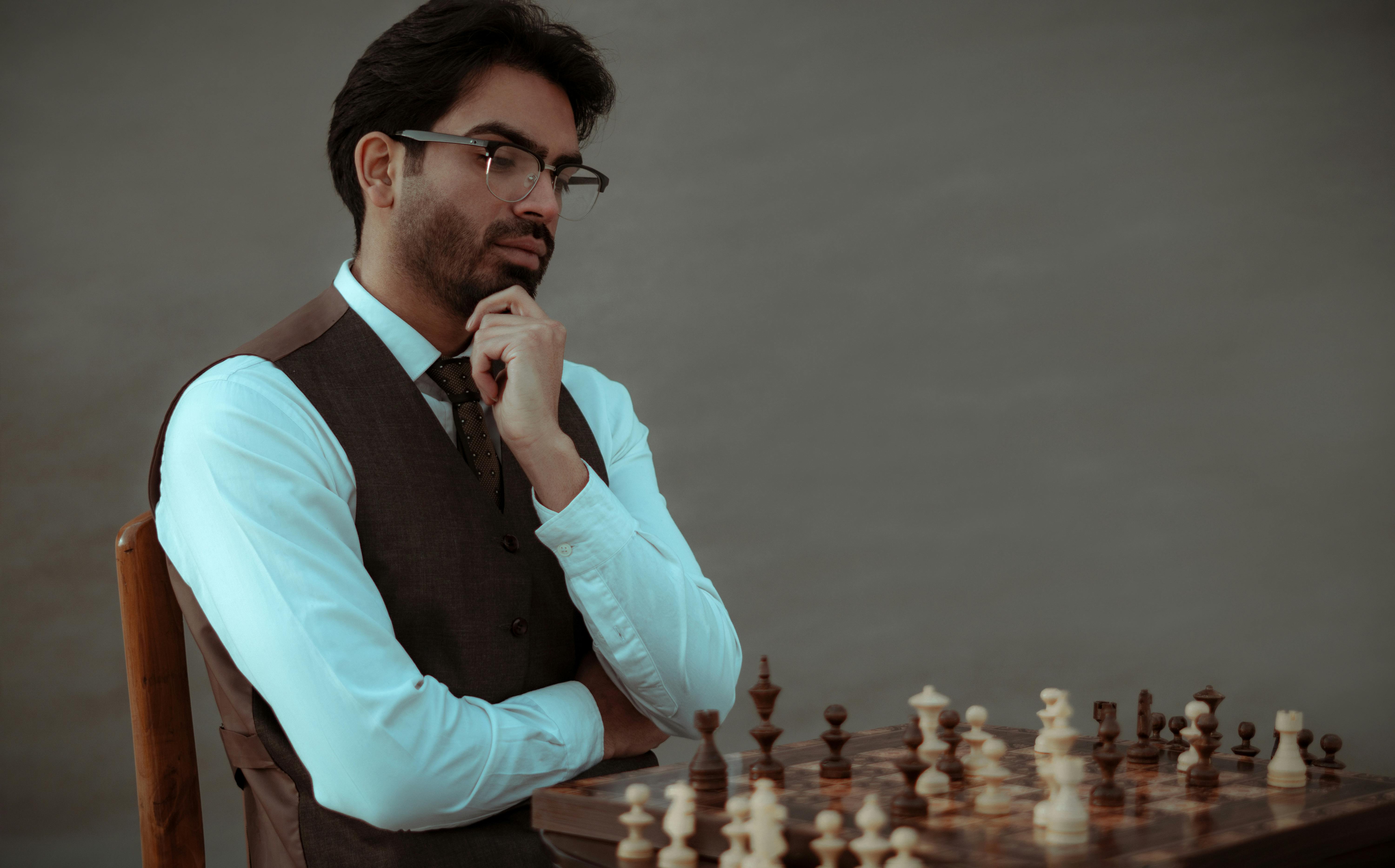 Man playing chess against computer - Stock Image - Everypixel