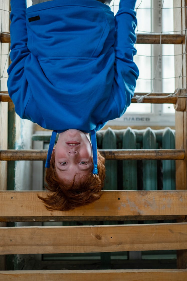 Man In Blue Hoodie Hanging Upside Down