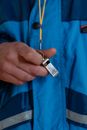 Hand Holding a Whistle