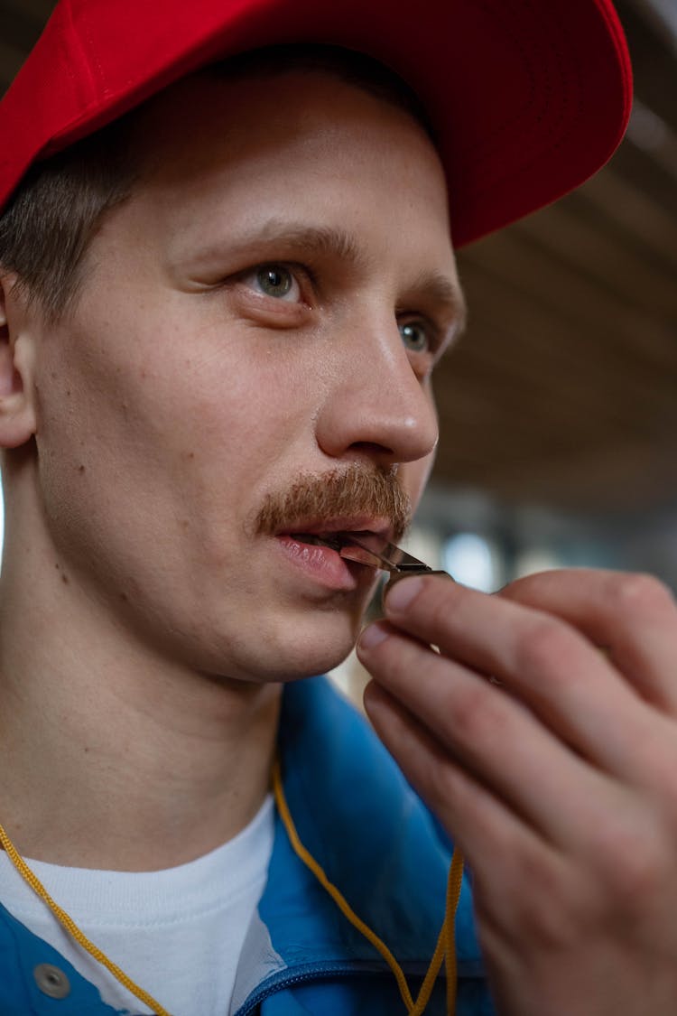 Close-Up Shot Of A Man Blowing A Whistle