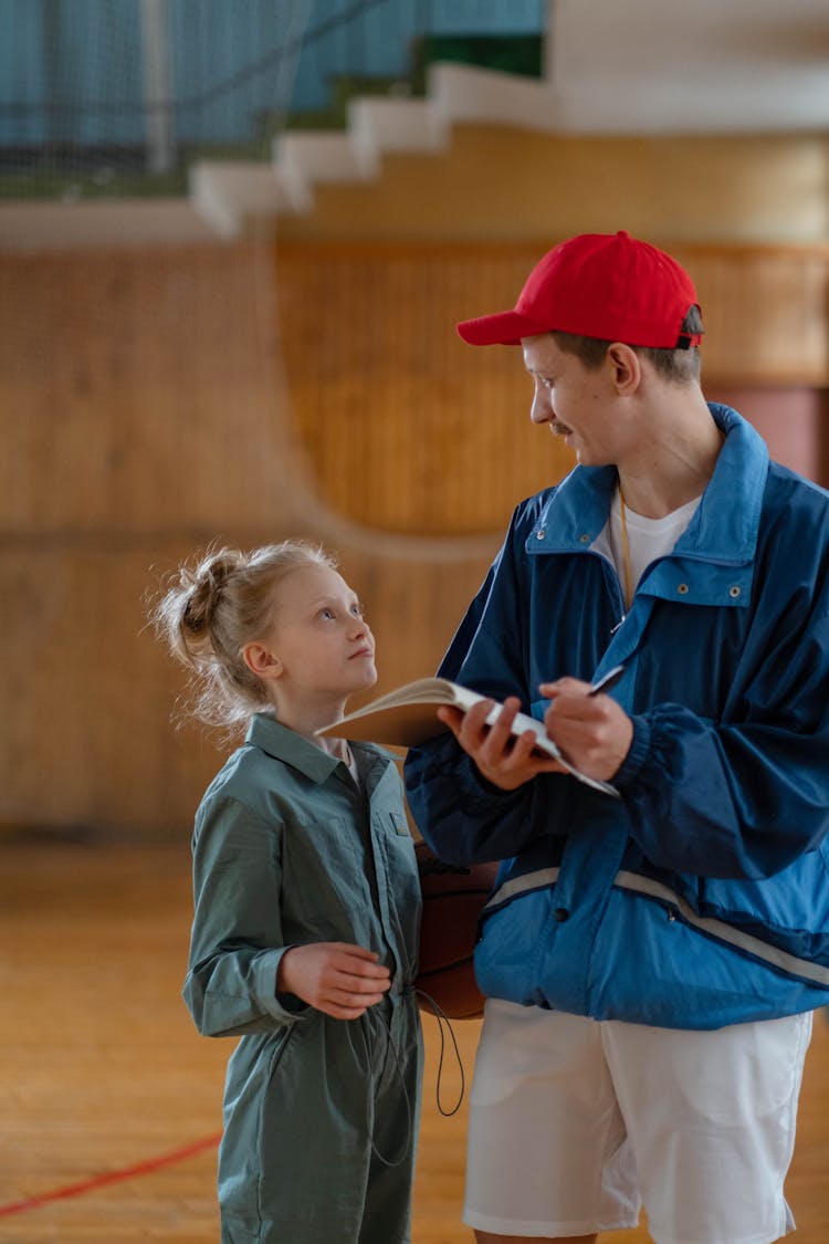 A Male Coach Talking To His Student