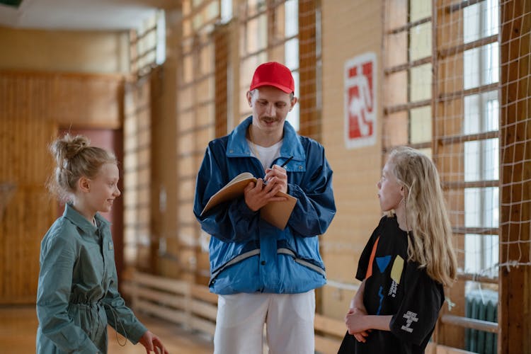 A Male Coach Talking To His Students