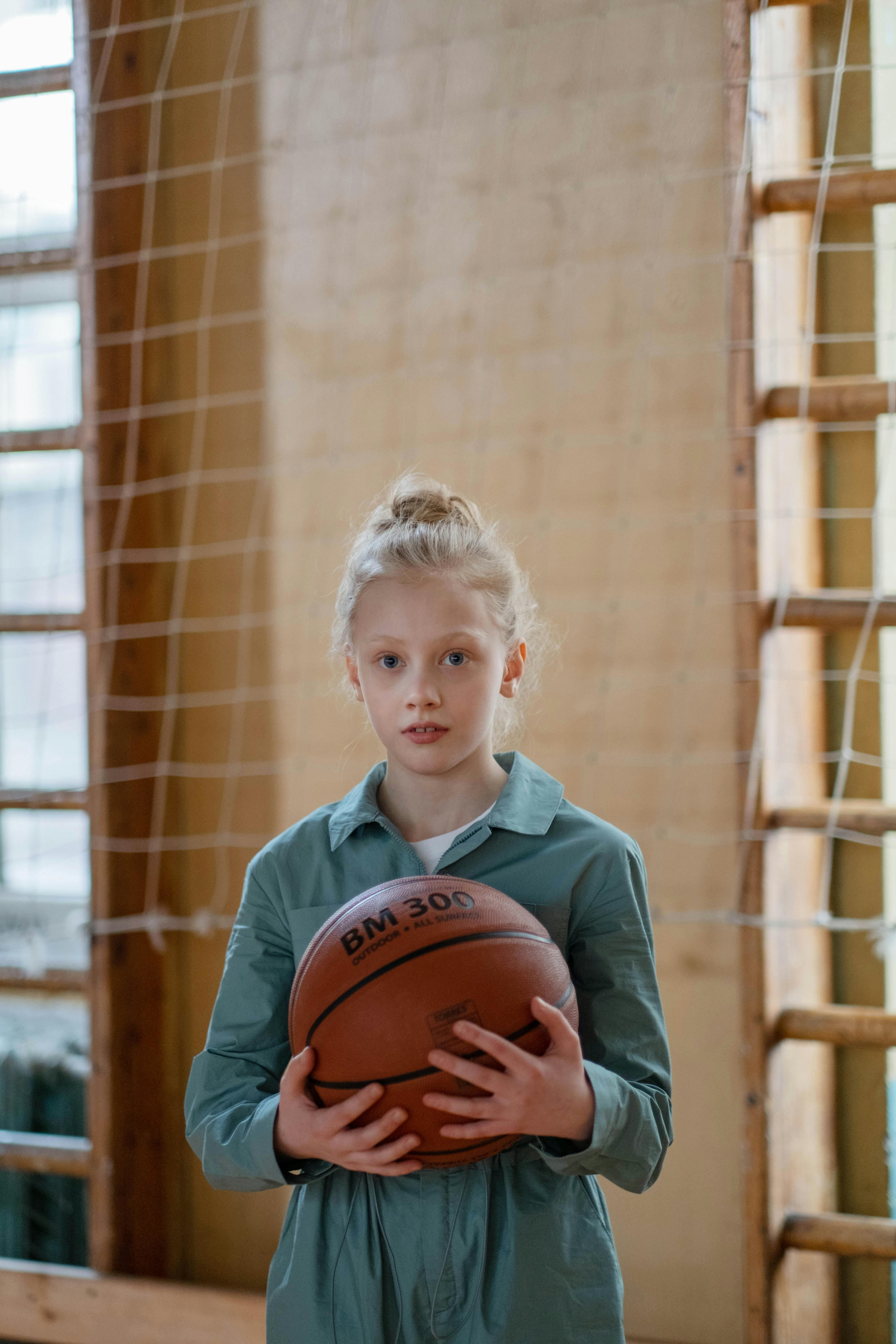 a girl holding a basketball