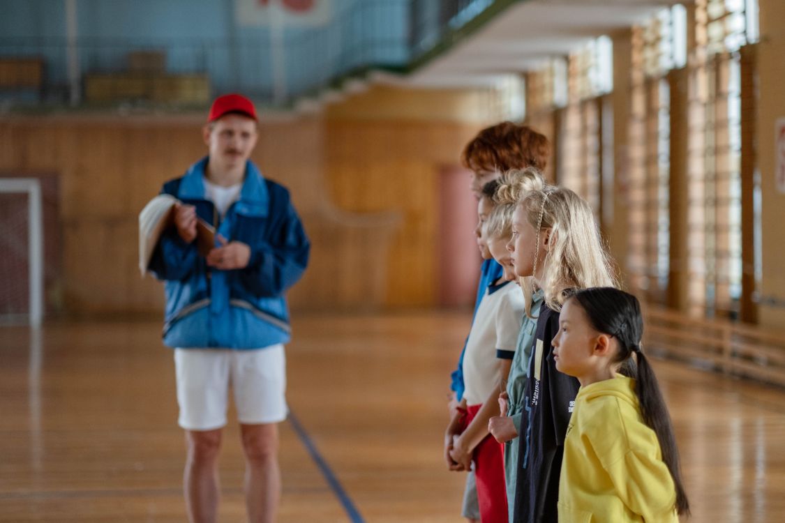 Children Lined Up Beside Their Teacher · Free Stock Photo