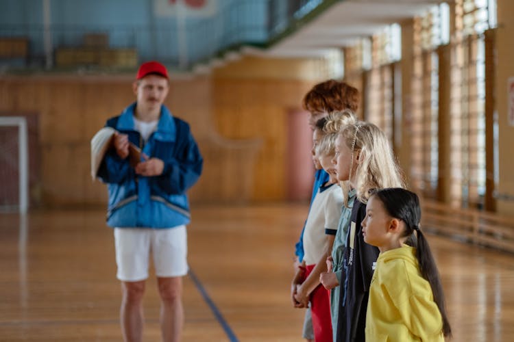 Children Lined Up Beside Their Teacher