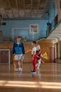 2 Boys Playing Basketball on Brown Wooden Floor