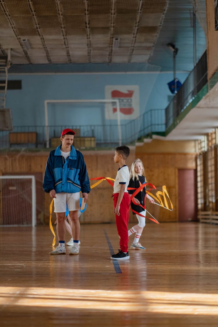 A Man Physical Education Teacher Coaching His Students