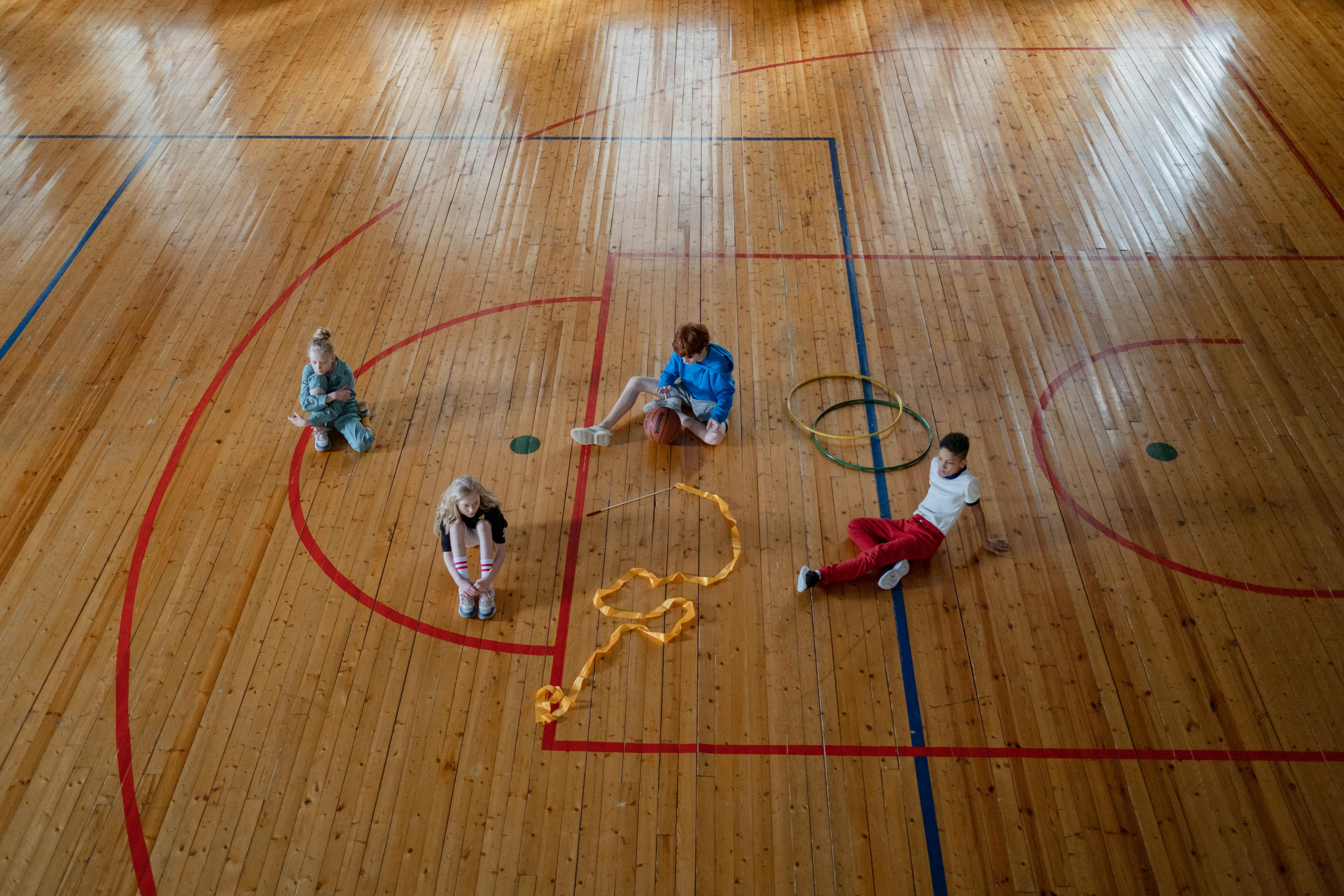 2 children playing on basketball court