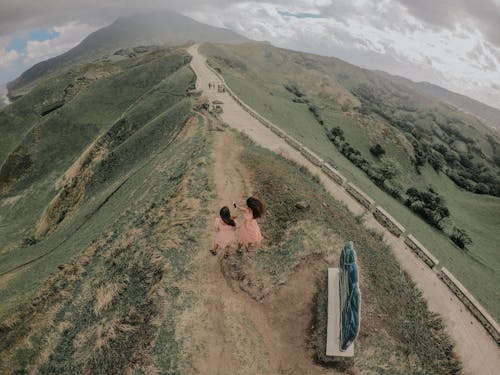Aerial Shot of Women Standing Near the Road