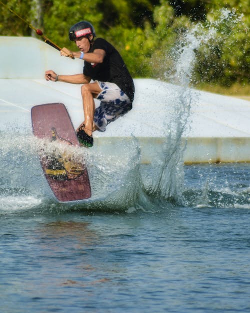 A Man Doing Tricks While Wakeboarding