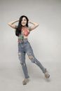 Woman in White Tank Top and Blue Denim Jeans