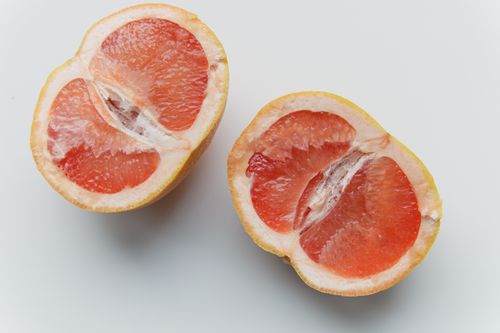 Free Close-up of fresh grapefruit halves against a clean white background. Stock Photo