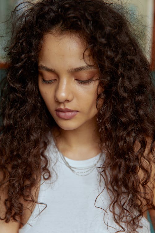 Close-Up Shot of a Pretty Curly-Haired Woman